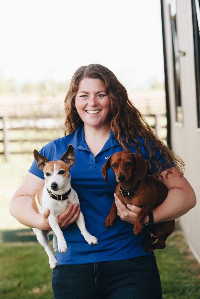 Staff photo of Christian Ackman and her dogs Jack and Henry